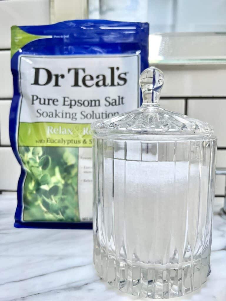 Epsom Salt in a glass jar with bag of Epsom salt behind it.
Budget-friendly bathroom spa experience.