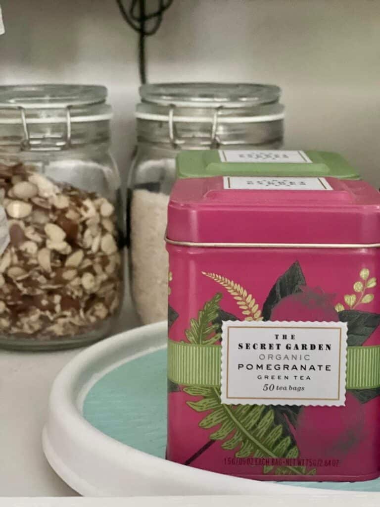 A pink box of tea sitting on a lazy Susan.