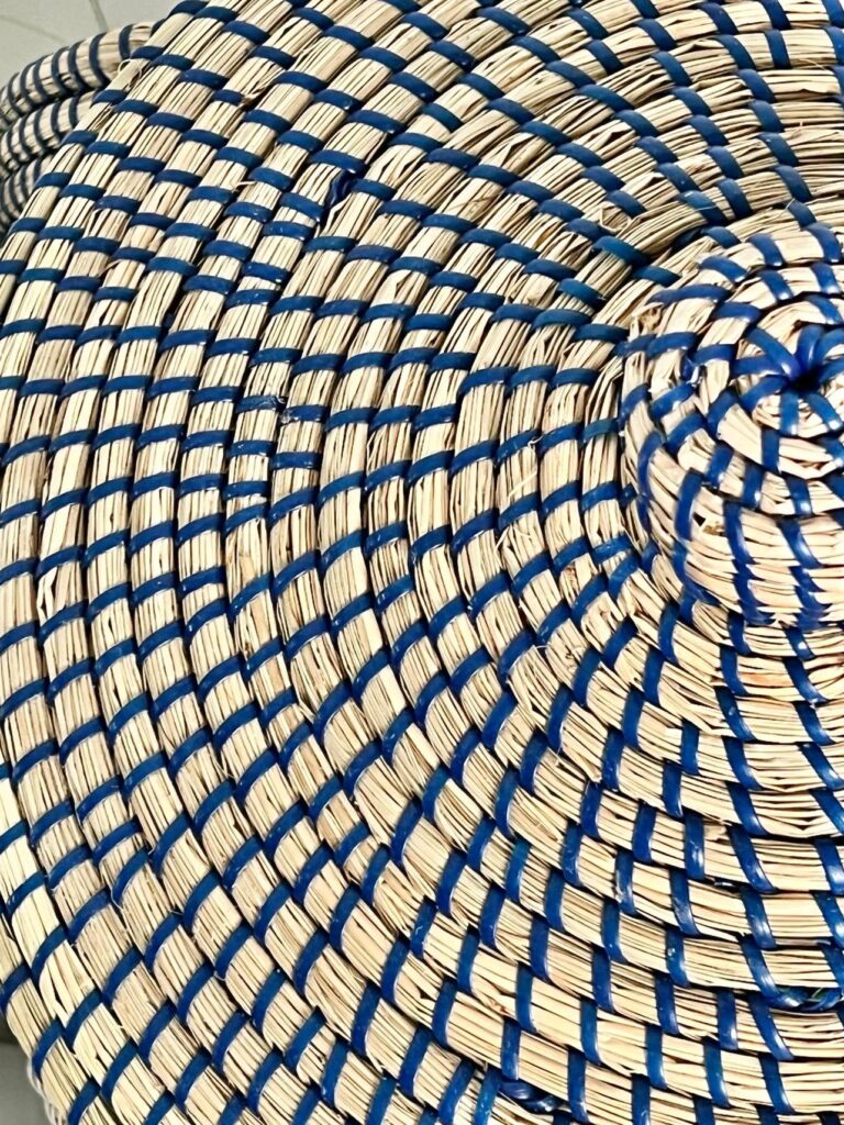 Colorful home decor. A rattan basket threaded with blue rope.