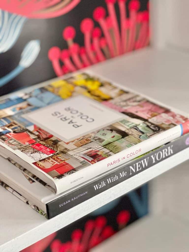 Coffee table books with colorful jackets are bookshelf home decor.