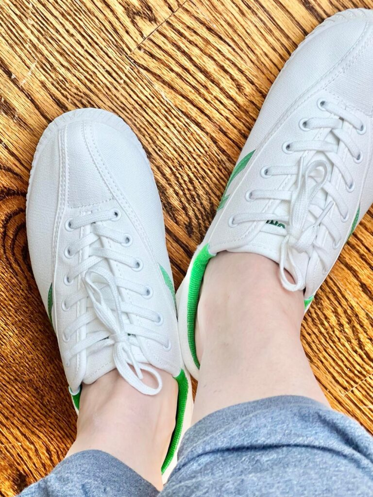 Missy Wearing the white and green sneakers.