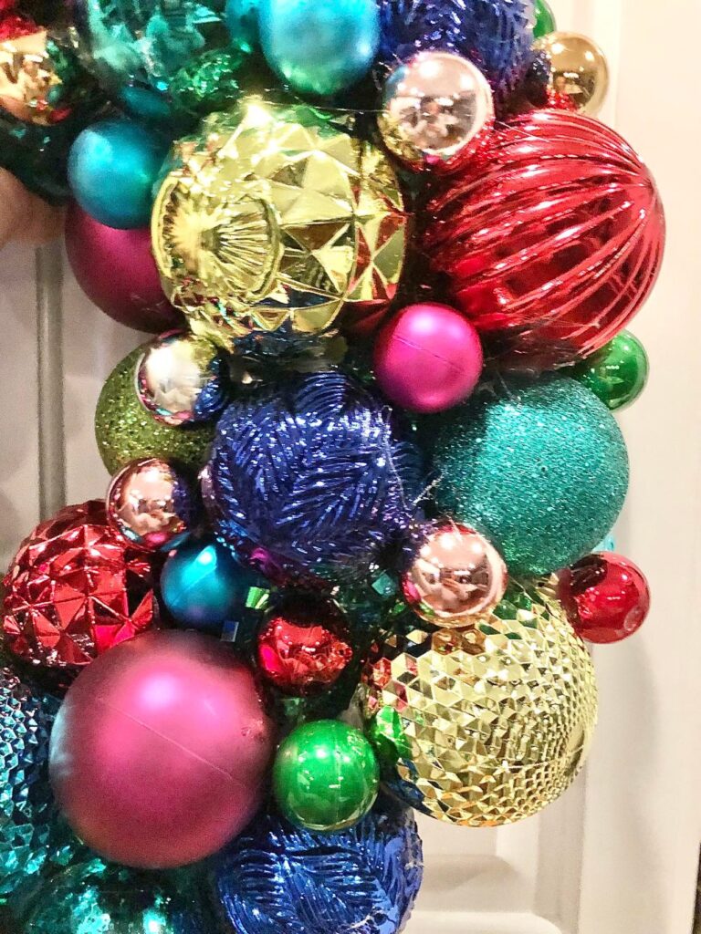Multi colored ornament balls on a wreath.