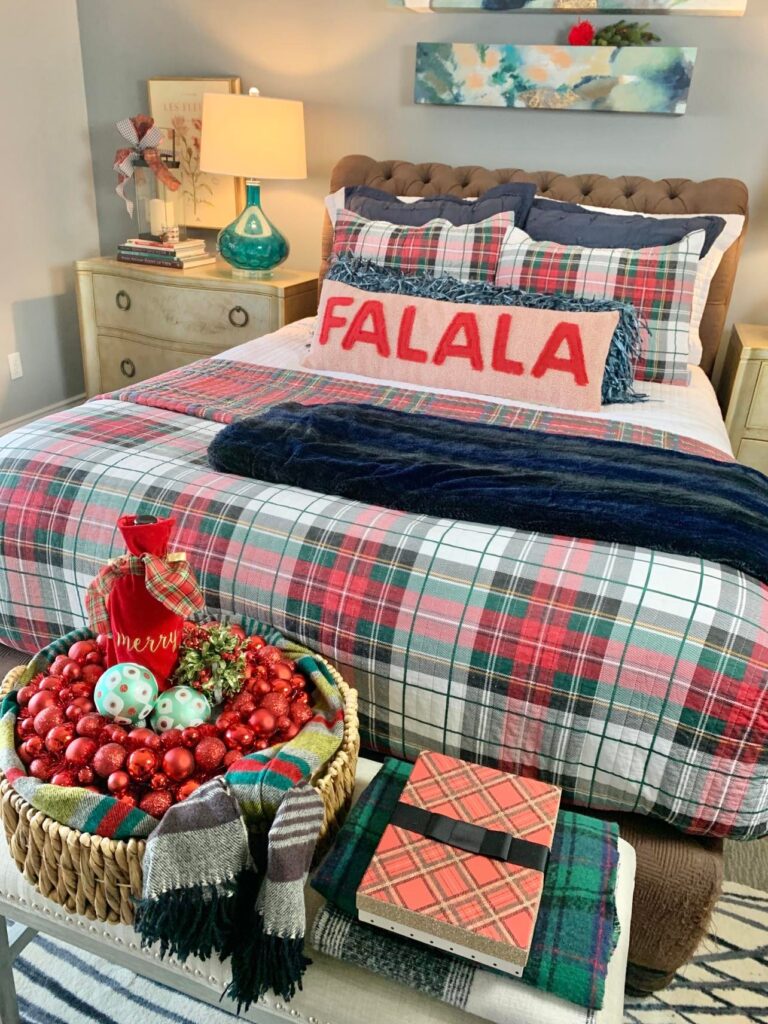 This Christmas color scheme consists of a red, green, and blue plaid that is displayed in a primary bedroom's bed.