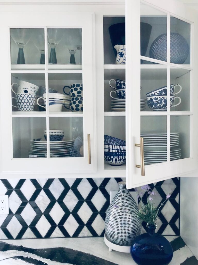 Blue and white dinnerware kitchen decor displayed in glass front cabinets.