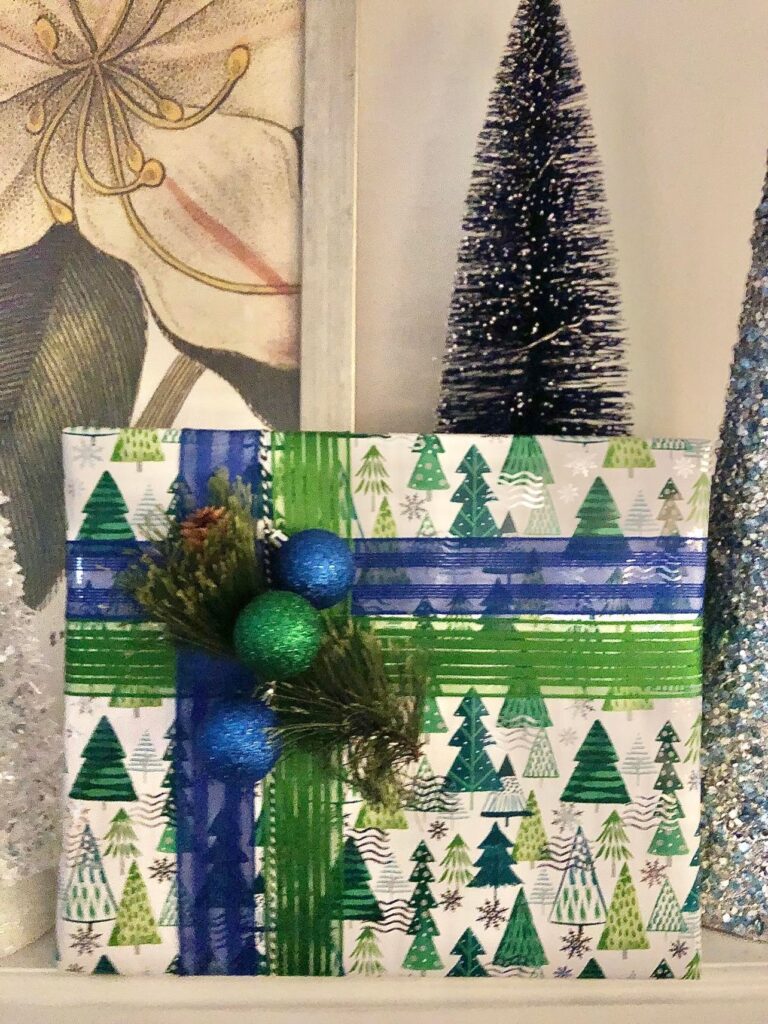 A package wrapped in the Christmas color scheme of blue and green paper and ribbon.