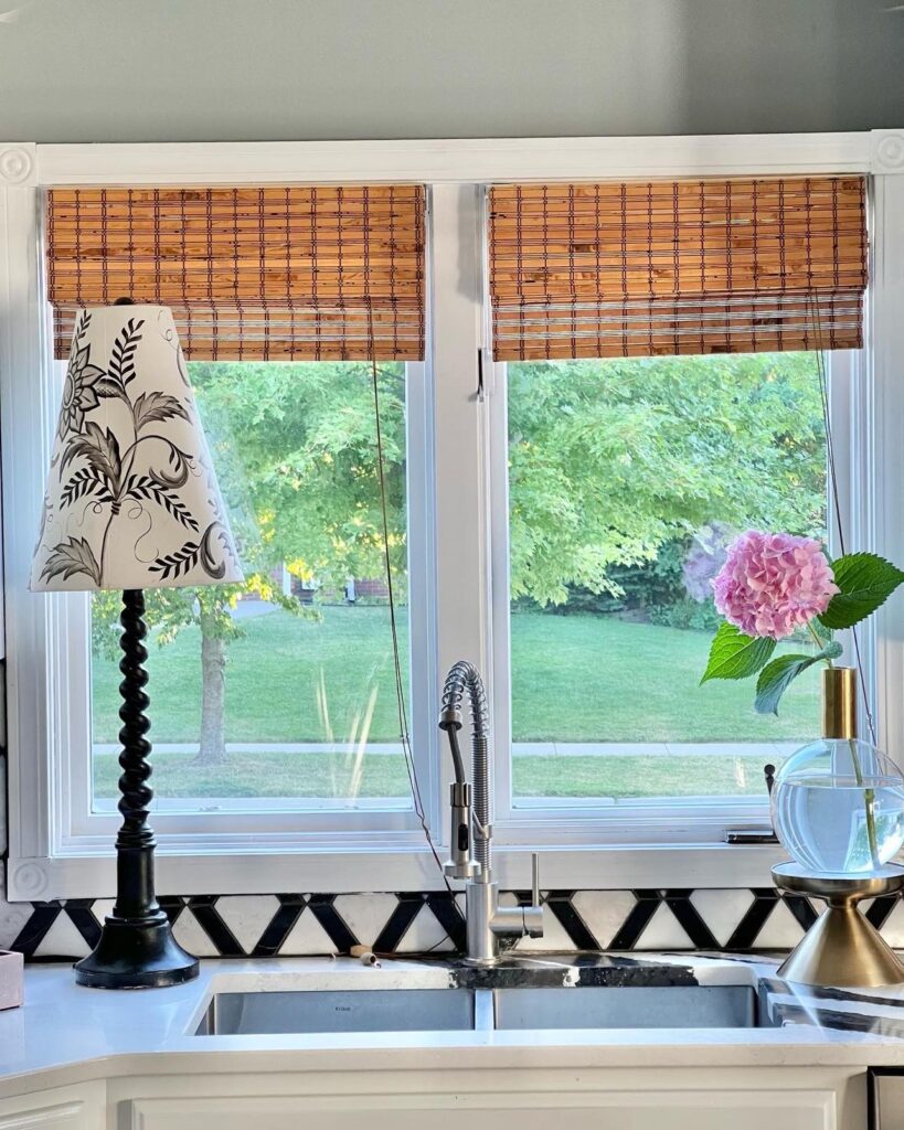 A hydrangea displayed as kitchen decor on the side of the kitchen sink.