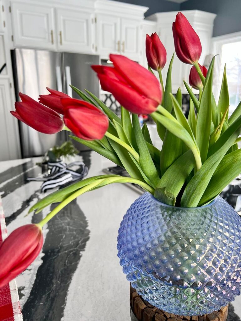 Red tulips are a beautiful kitchen island decor choice.