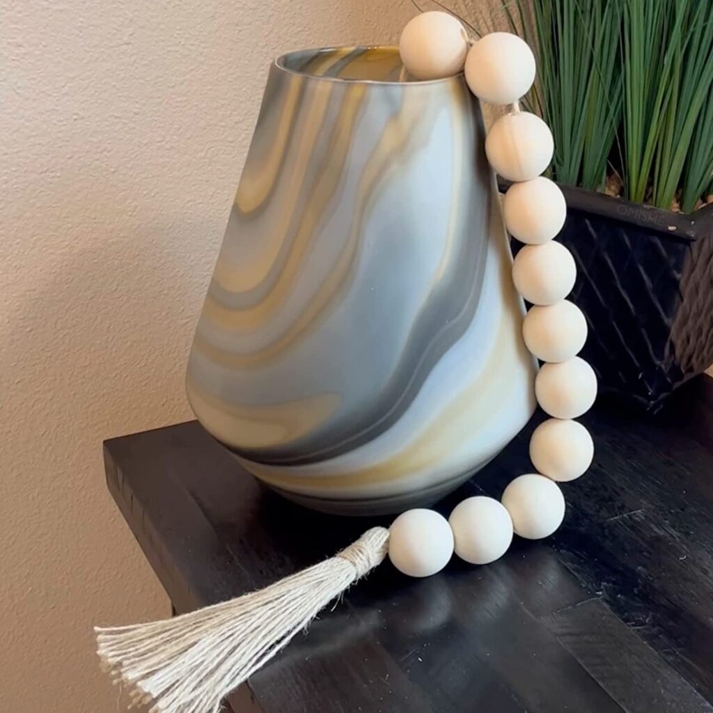 a large bead garland draped on a vase.