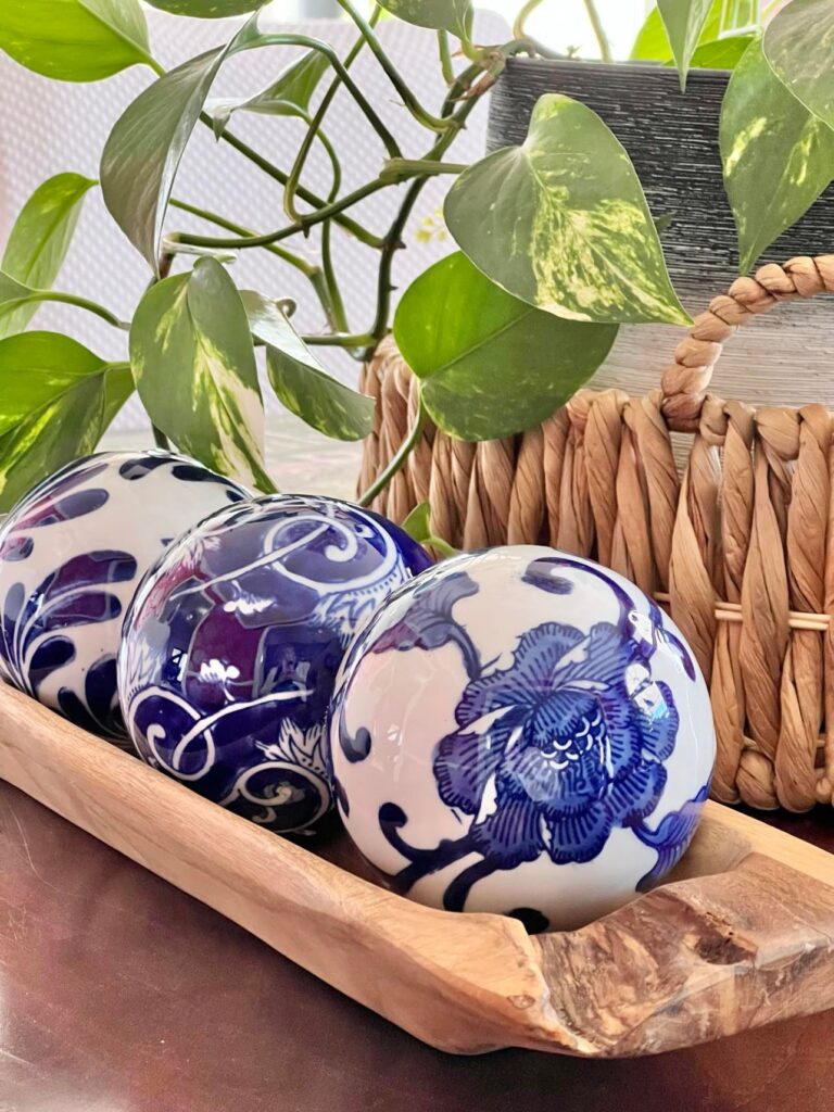Blue and white ceramic decor balls are an excellent idea for filling a dough bowl.
