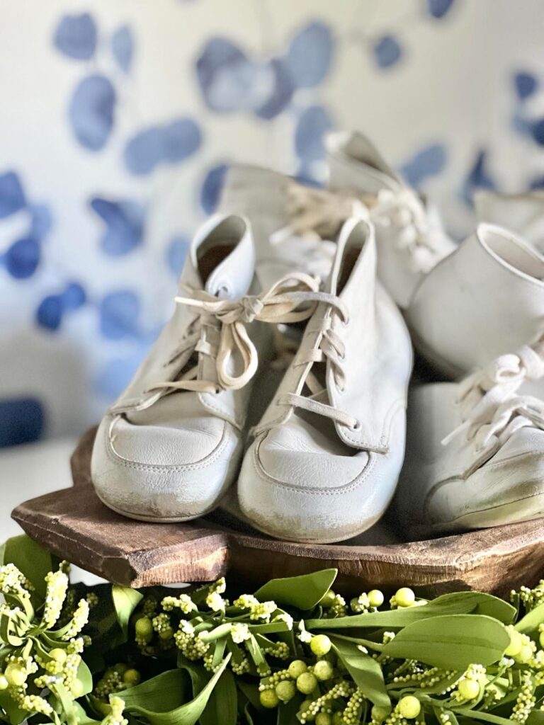A great sentimental dough bowl decorating idea is to fill the bowl with the baby shoes of your children.