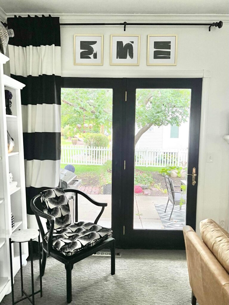 The view into the back patio is accented by the framed wall art hack above the doors.