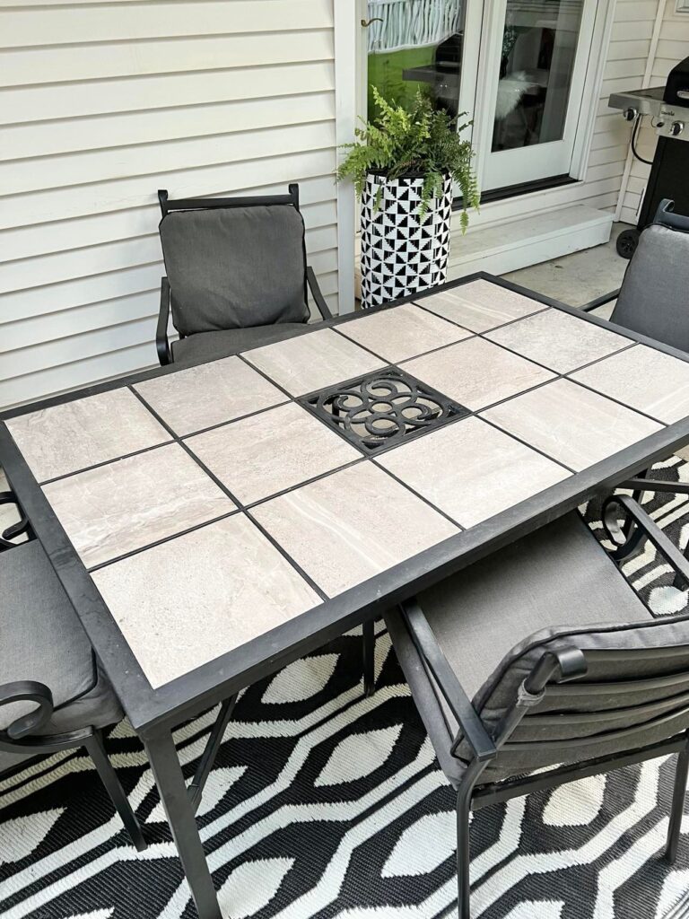 A black and grey patio table before the DIY makeover.