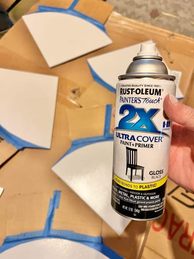 Spray painting the exposed tile with black Rust-Oleum spray paint.