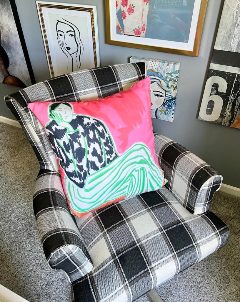 A whimsical pillow called "Calm Woman" give this plaid desk chair some style.