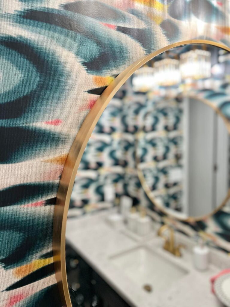 The blue and gold colors in the room are reflected colorful home decor in a mirror.