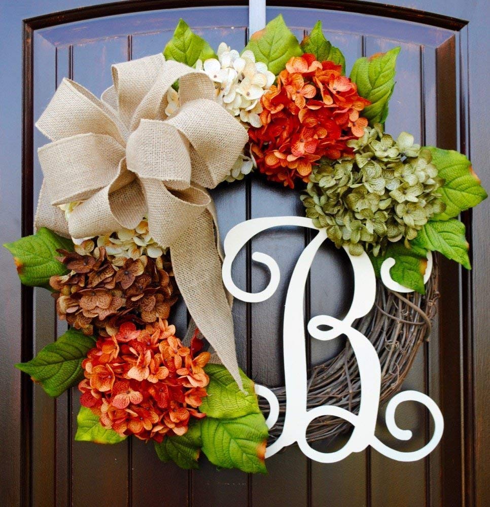 A hydrangea fall wreath with attached monogram initial listed on Etsy.