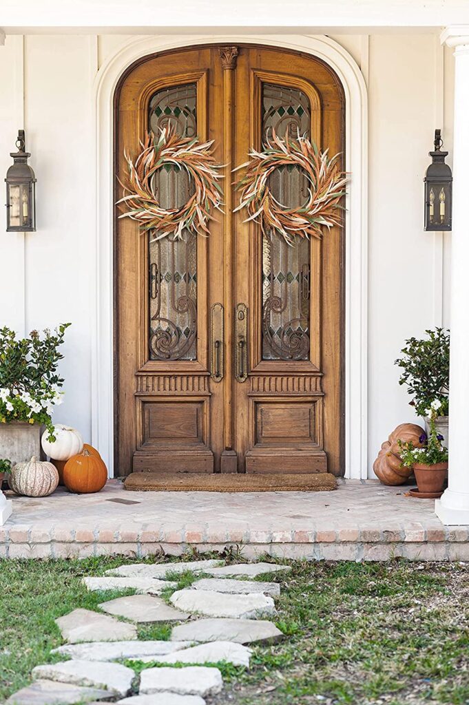 Wheat wreaths from Amazon hanging on double doors.