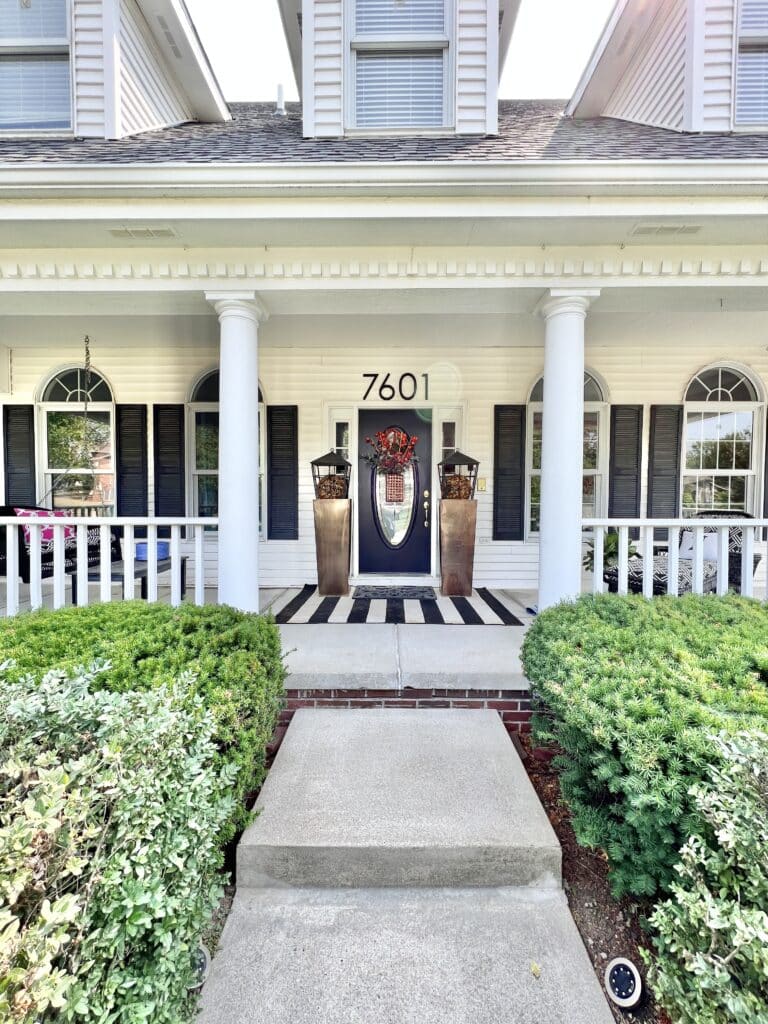 A front door's glass insert decorated with DIY decor.