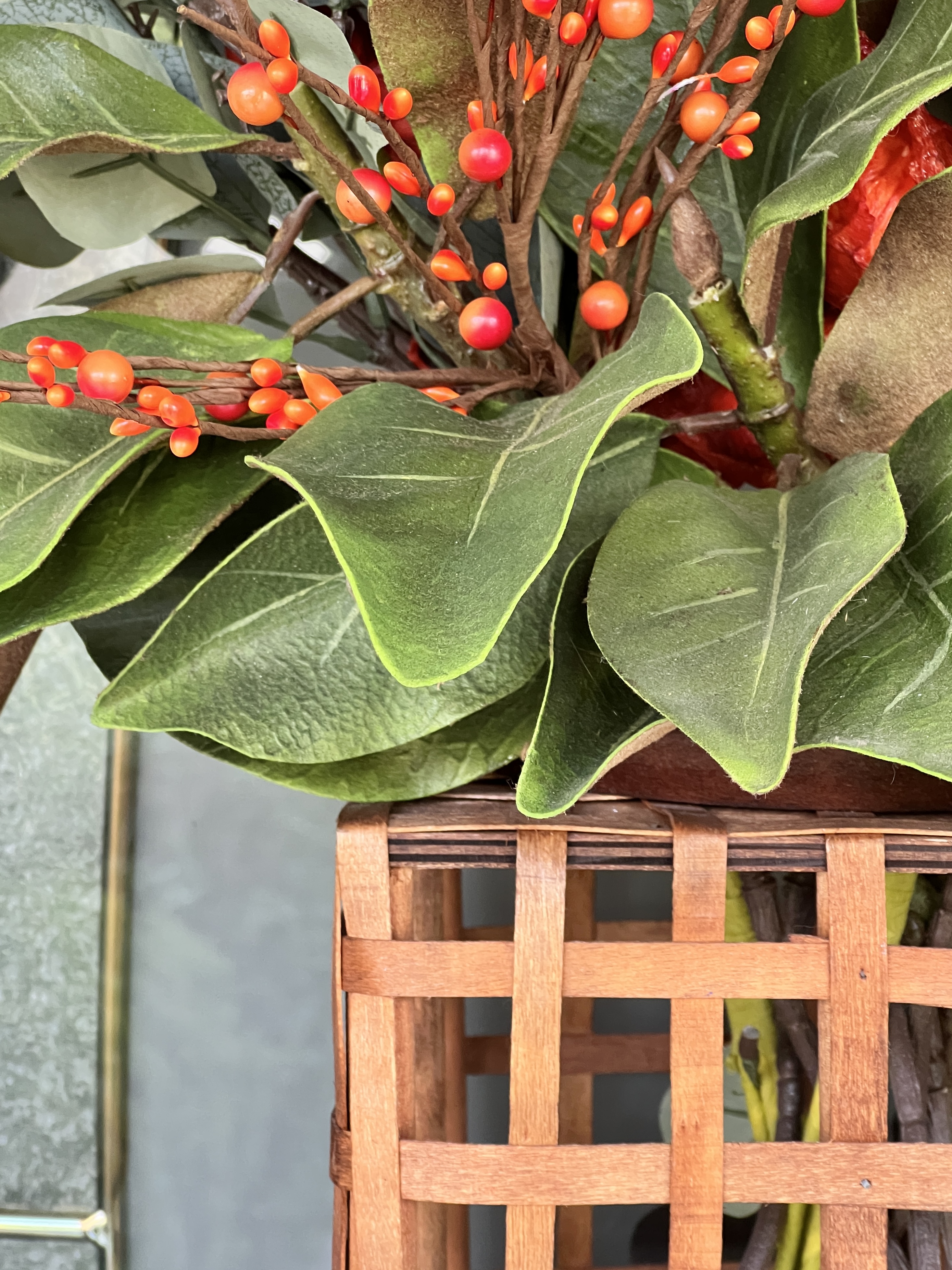 Magnolia leaves displayed in a door basket.