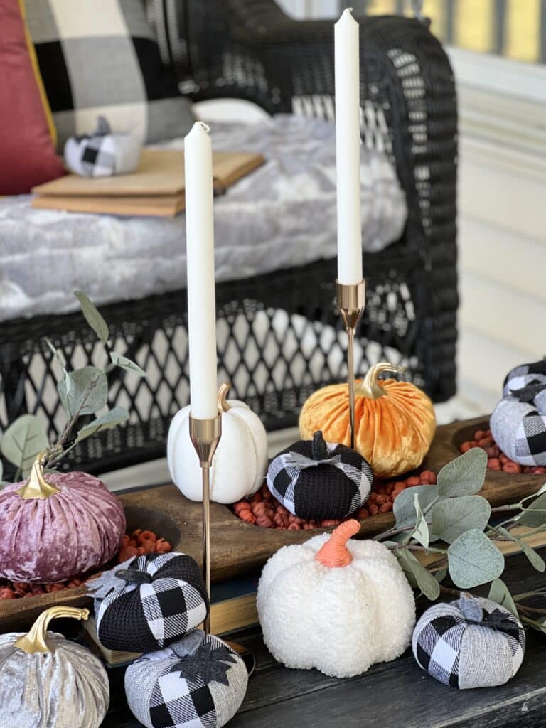 Pumpkins and candlesticks tucked into a dough bowl.