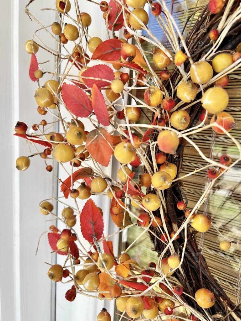 A mixed berry fall wreath hanging from the side entrance to our home.