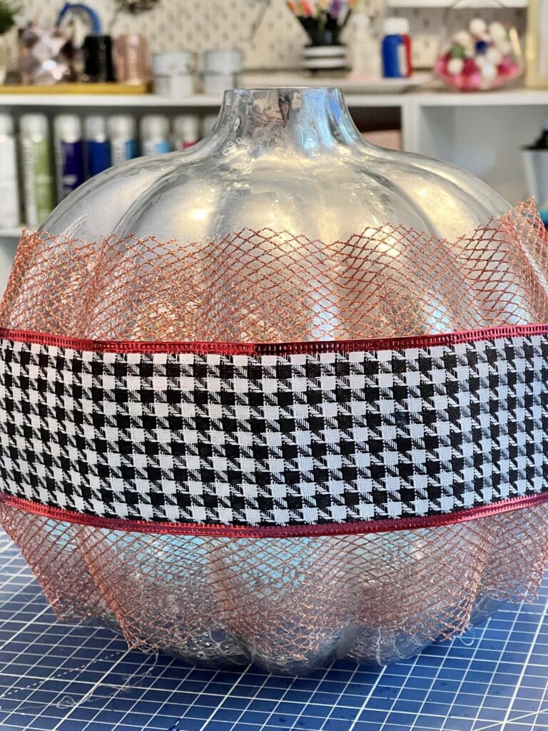 Copper mesh ribbon and houndstooth ribbon added to the glass pumpkin.