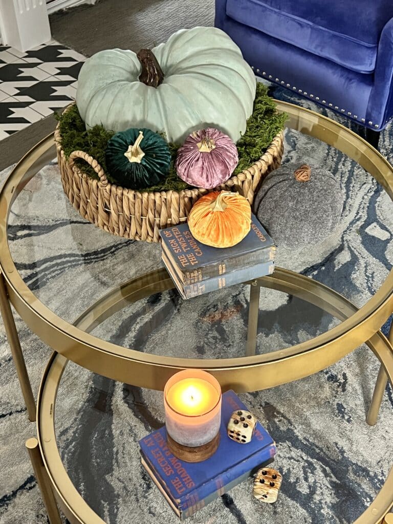 The round coffee table is styled with fall decor for this living room fall tour.