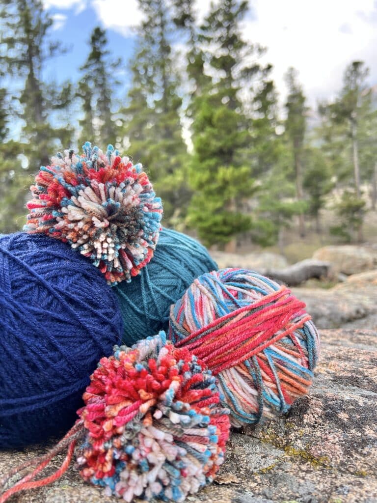 A stack of yarn with a pom pom.