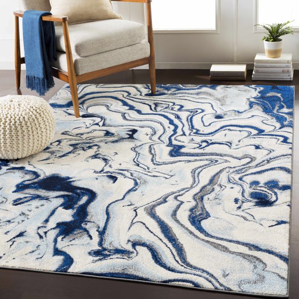 A blue and white abstract area rug in a living room from Amazon.