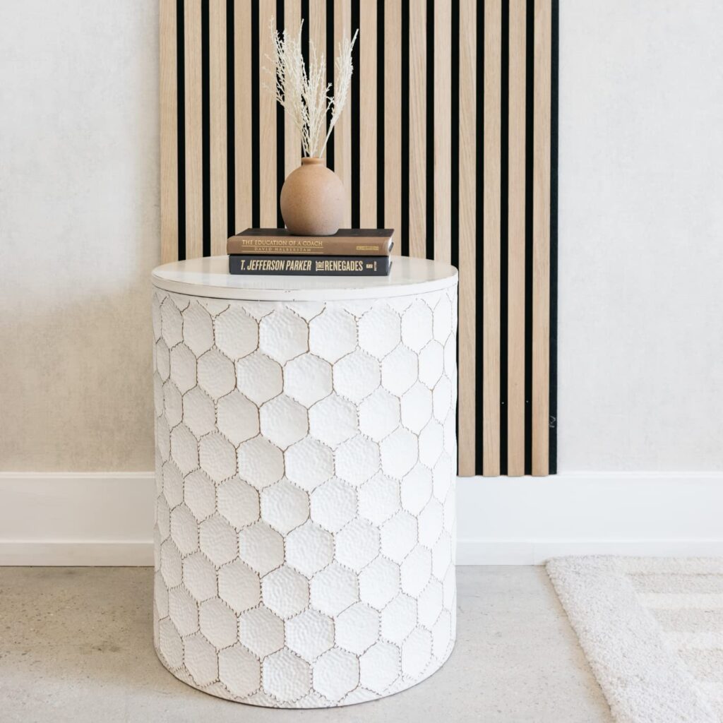 A white geometric honeycomb accent table you can buy through Amazon.