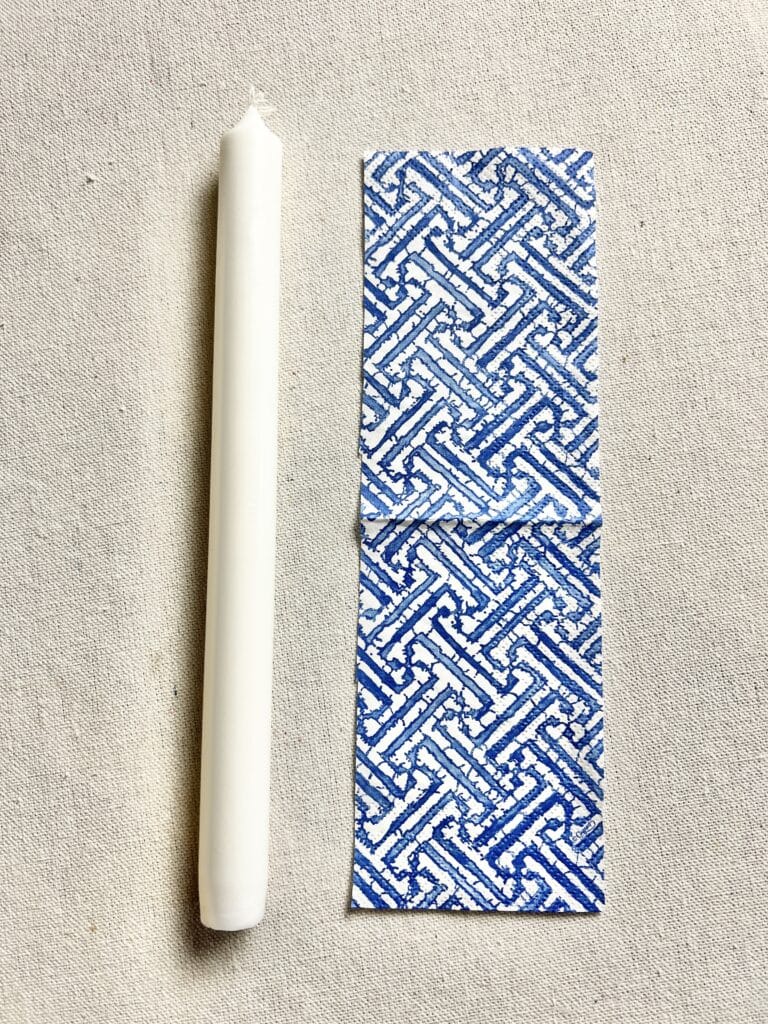 This DIY candle idea starts with a taper candle and patterned paper napkins.