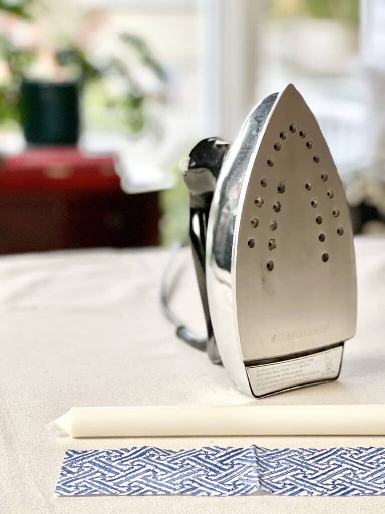An iron to be used in attaching the paper napkin in this DIY candle idea.
