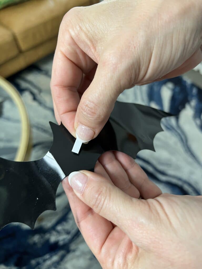 Bending the bat wings and attaching the double sided stickers.