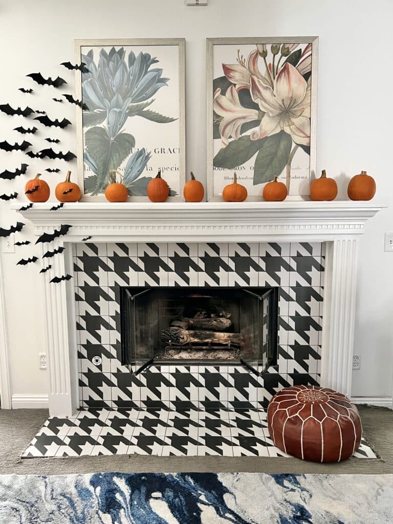 Plastic bats attached to a fireplace and surrounding wall for spooky Halloween decor.