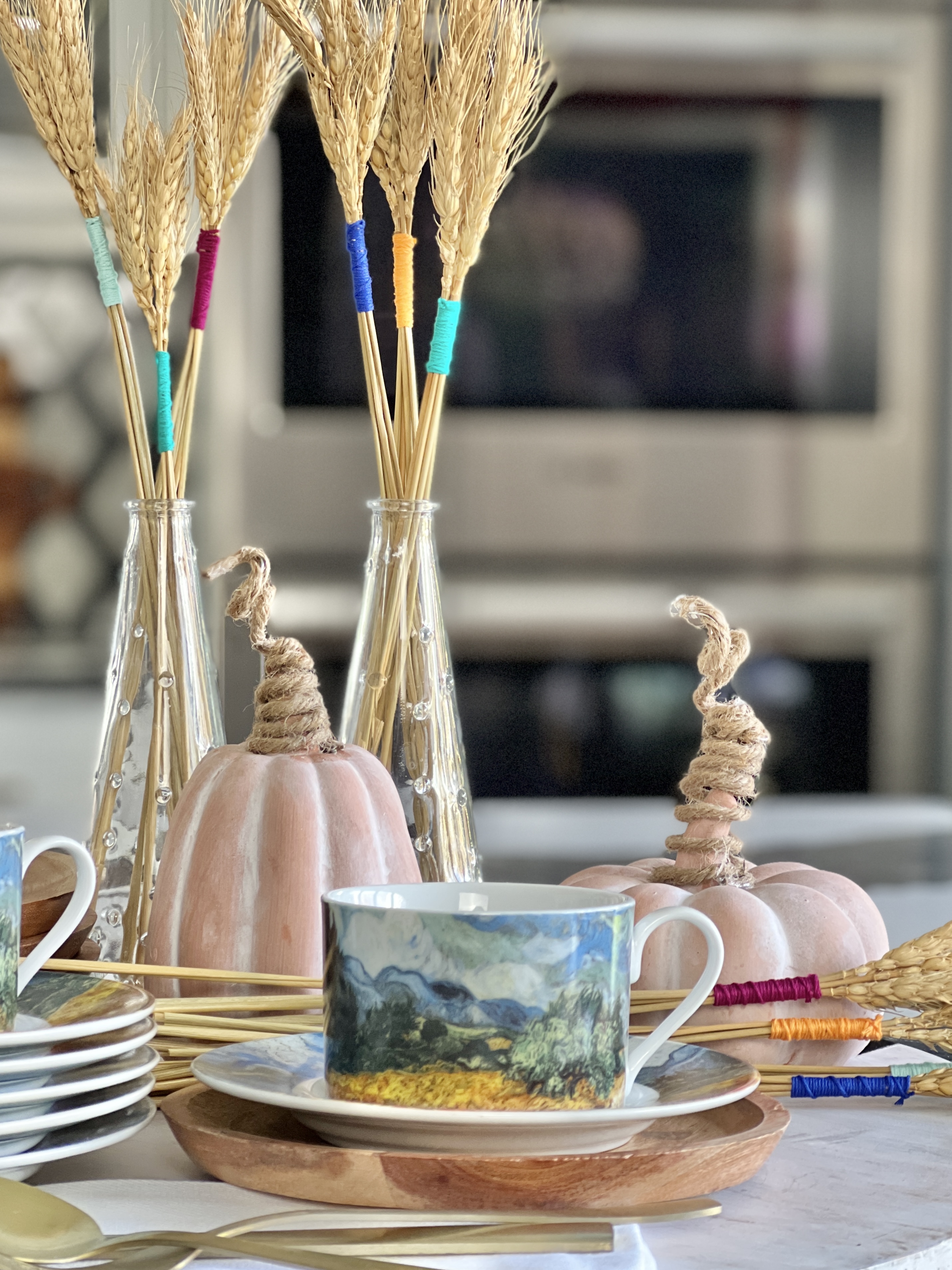 Smaller wheat bundles fit perfectly in small glass vases as an easy Thanksgiving decor idea for your table.