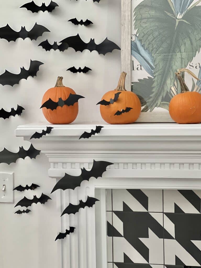 Fanciful faux bats attached to the side of the fireplaace mantel.