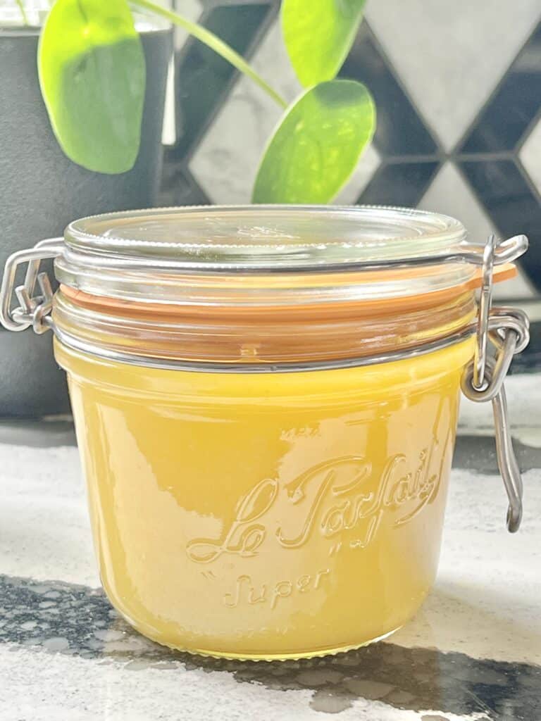 A glass jar of fresh lemon curd.