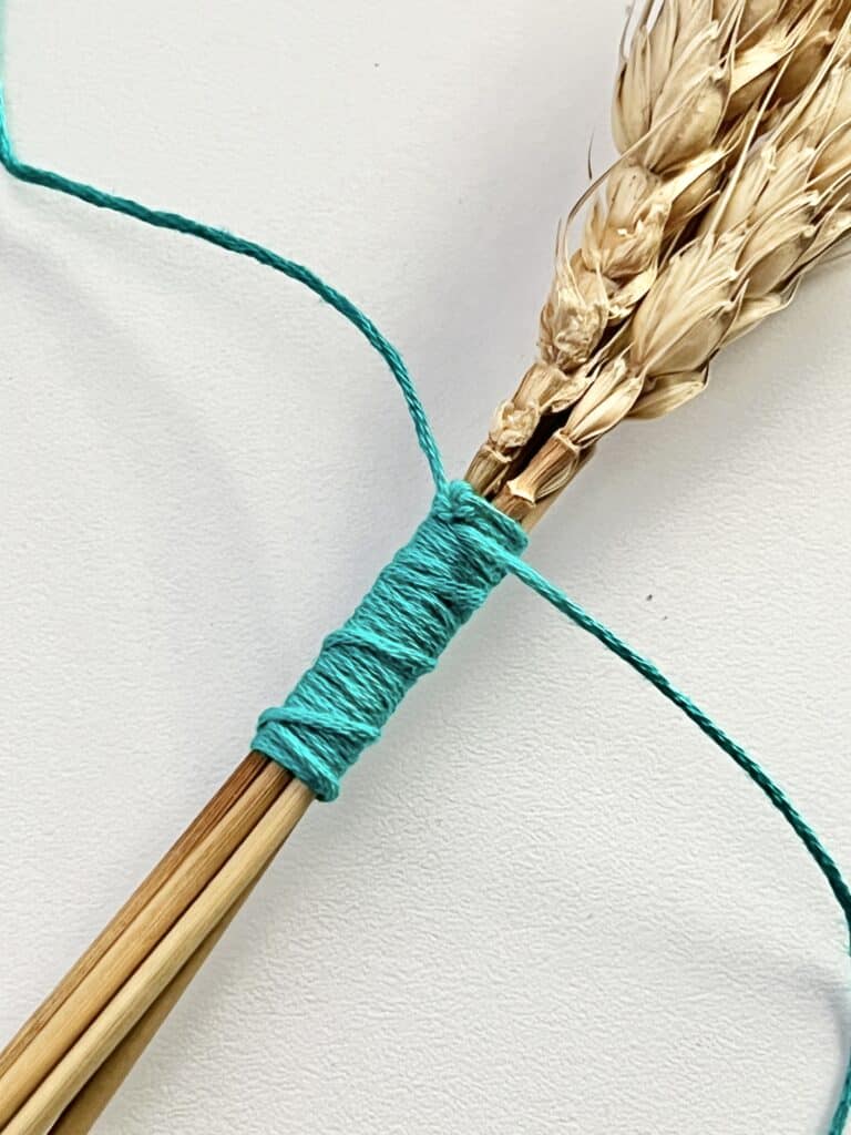The tails of the embroidery thread tied in a knot.