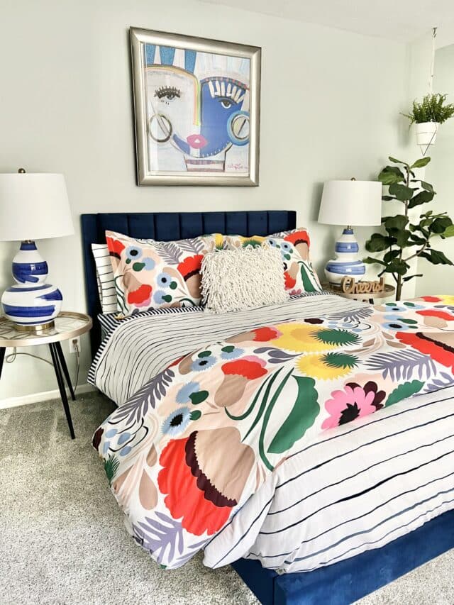 A colorfully dressed guest room bed.