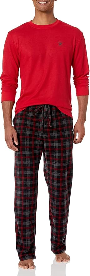 A man wearing a red shirt and plaid lounge pants.