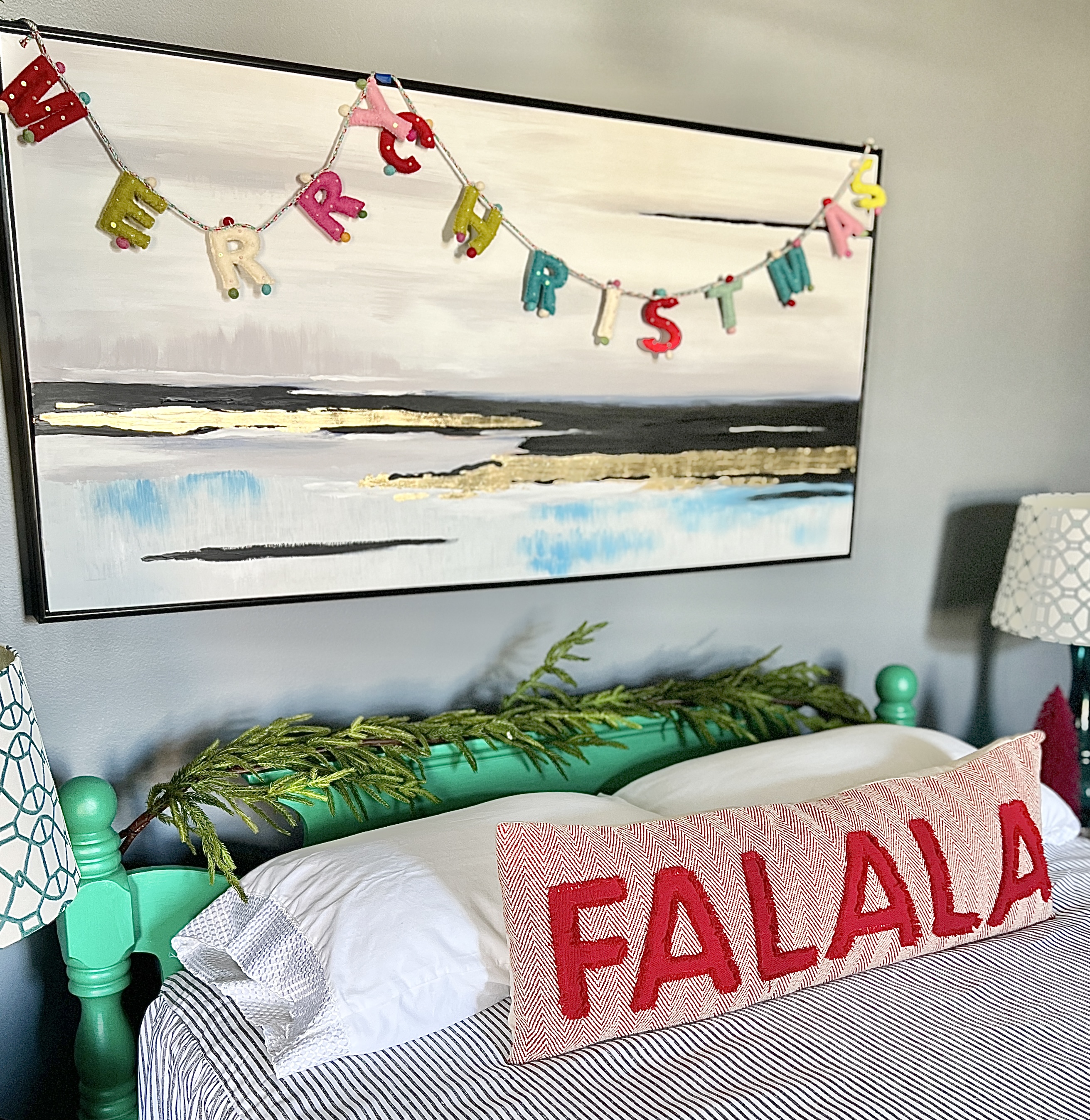 A cheerful "Merry Christmas" message hanging above the painted headboard.