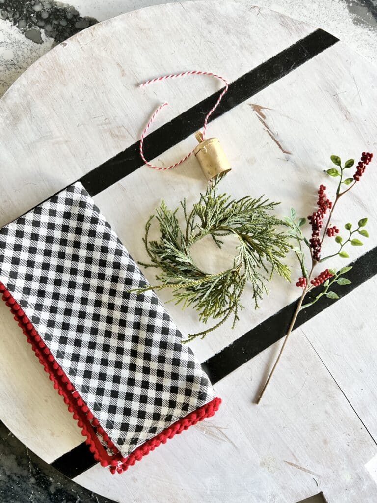 Components of a ringed holiday napkin to make Christmas centerpiece ideas.