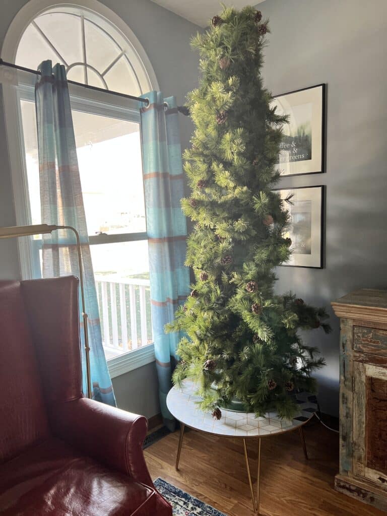 The old Christmas tree sitting on a coffee tab le for height.