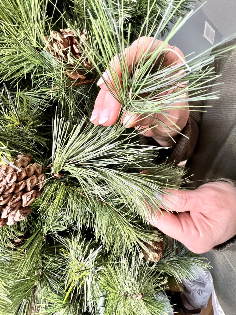 Fluffing the needles of the tree.