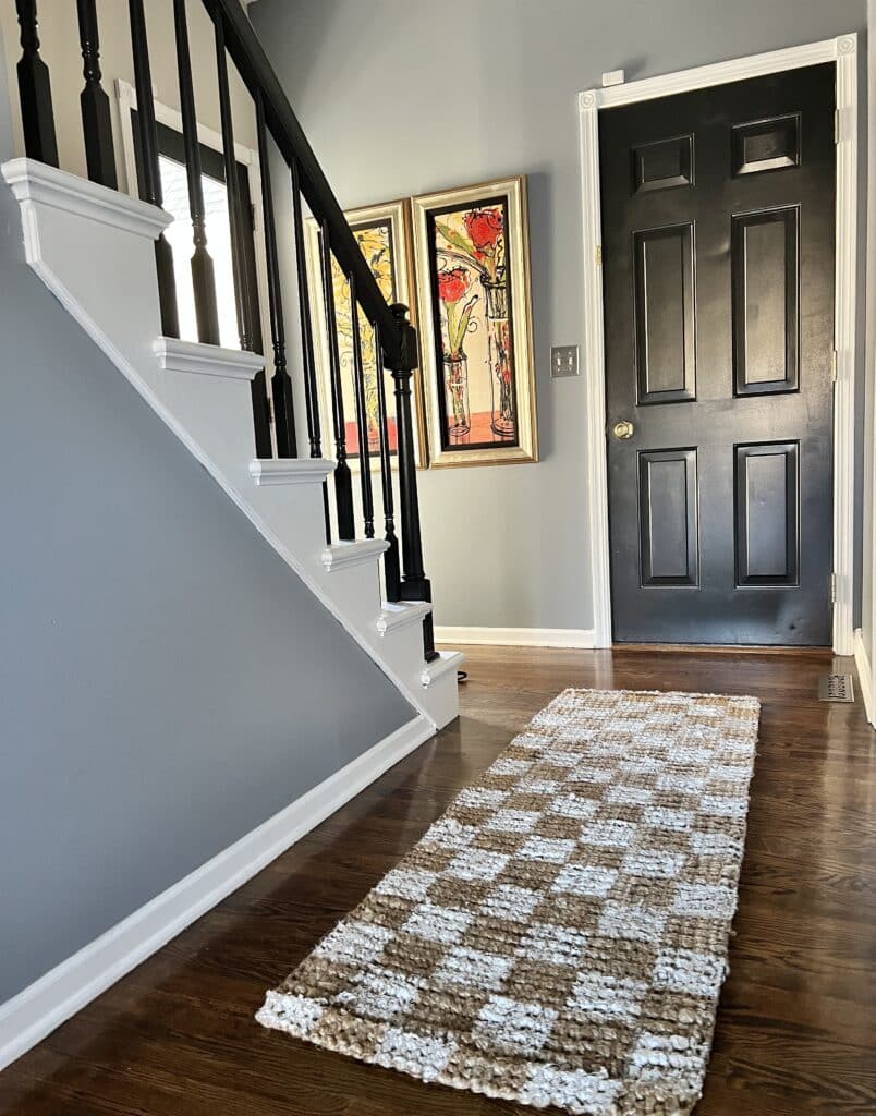 A jute rug DIY painted checkerboard project displayed in a hallway.