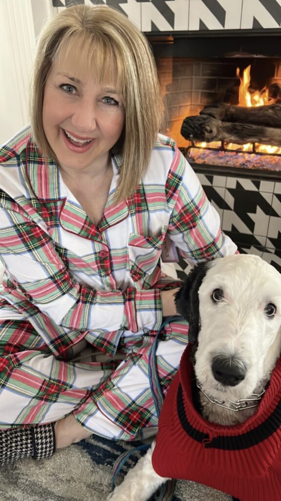 Missy in plaid pajamas with her dog, Bentley.