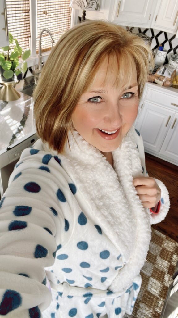 Missy in a blue and white polka dot robe.