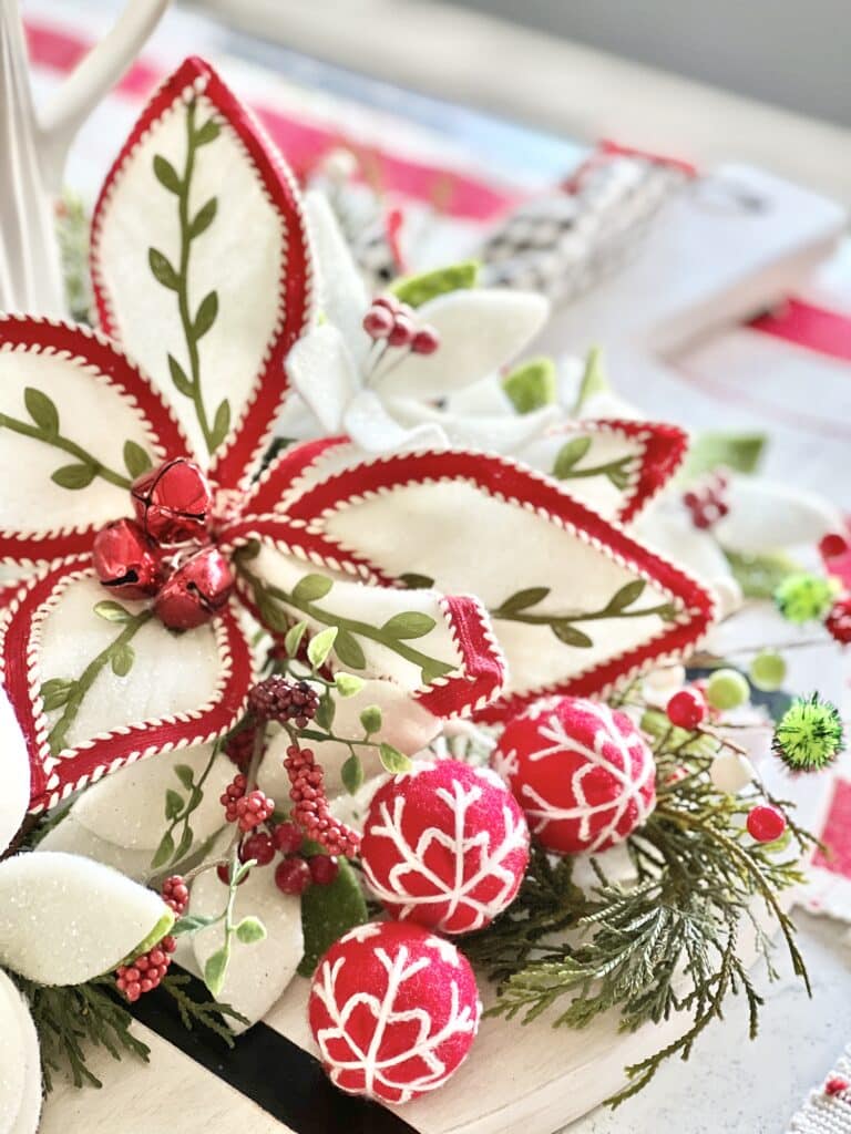 A red, white, and green felt poinsettia.