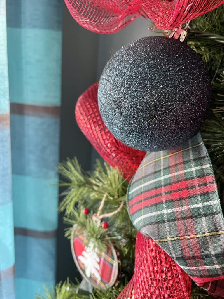 A navy blue glittered ornament.