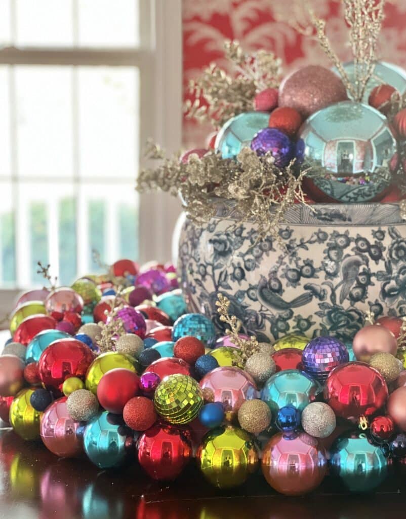 A blue and white pot surrounded by Christmas ornaments.